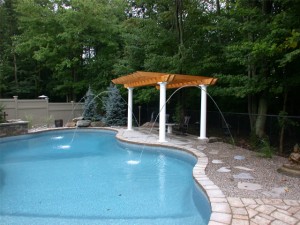 petite fountain streams into a large in-ground pool - located in Ottawa