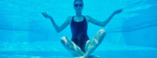 a woman under the water in her pool