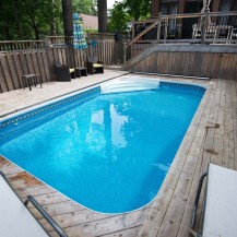 In-ground swimming pool surrounded by beautiful decking