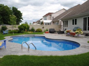 Large curvy in-ground swimming pool in the heart of Ottawa suburbs