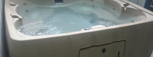 simplistic beige hot tub installed in Ottawa backyard