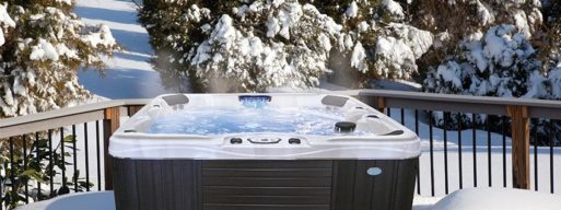 steaming hot tub with snow and trees in the backdrop