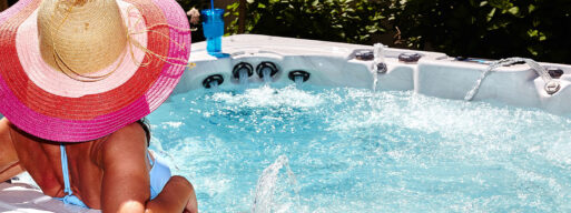 Woman in a hot tub with a sun hat on